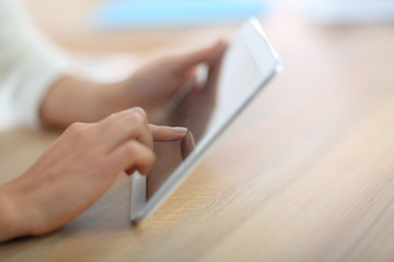 Closeup of hand sliding on digital tablet - obrazy, fototapety, plakaty