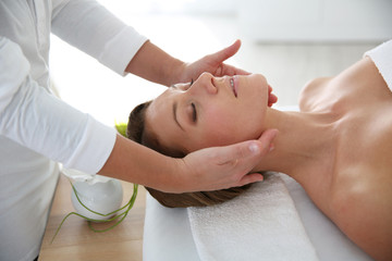 Obraz na płótnie Canvas Woman having a face massage in beauty institute