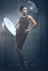 A woman in fashion dress over a glamour background