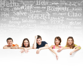 A group of teenagers with a giant, blank, white billboard
