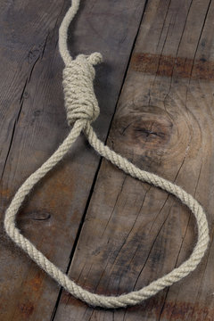 Noose on wooden background