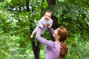 Young woman playing with her little daughter