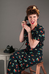 Pinup Girl in Flowered Outfit Grimaces While on the Telephone