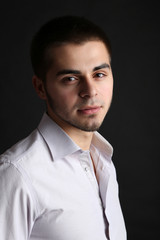 Handsome young man on dark background