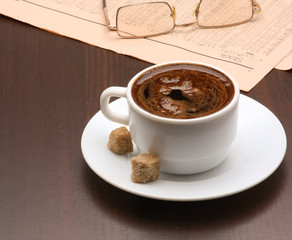 Cup of coffee and newspaper