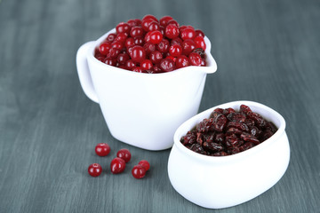 Fresh and dry cranberry in pitchers and bowl