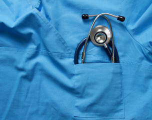 A stethoscope on a medical uniform, closeup.