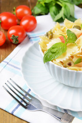 Delicious pasta with tomatoes on plate on table close-up