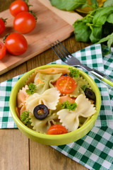 Delicious pasta with tomatoes on plate on table close-up