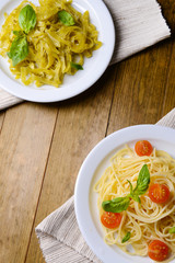 Delicious spaghetti with tomatoes on plate on table close-up
