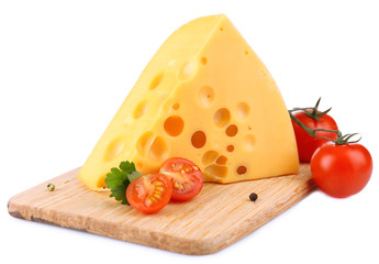 Piece of cheese and tomatoes, on wooden board, isolated on