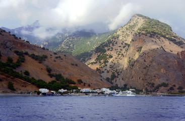 Mountains and town on the sea coast , island of Crete