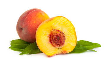 Three perfect, ripe peaches with a half  and slices isolated on
