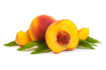 Three perfect, ripe peaches with a half  and slices isolated on