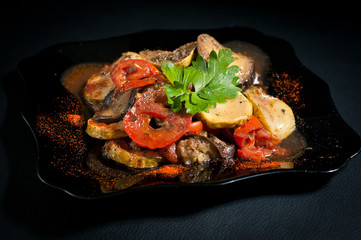 Vegetarian ratatouille on black plate