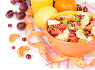 Sweet fresh fruits in bowl on table close-up