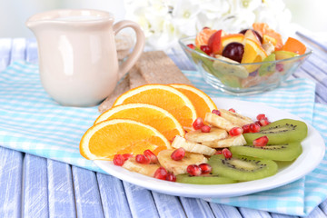 Sweet fresh fruits on plate on table close-up