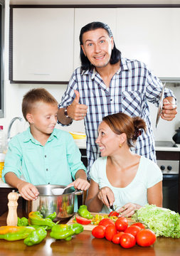 Happy family cooking food together