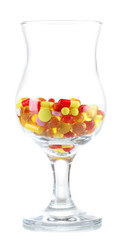 Goblet with pills isolated on white