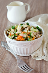 Salad with chicken, carrots, eggs and cucumbers