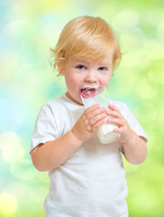 Child drinking dairy product from glass