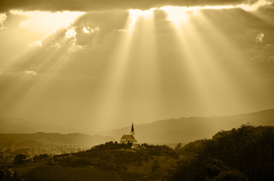 Fototapeta Sun rays shining down on a Church