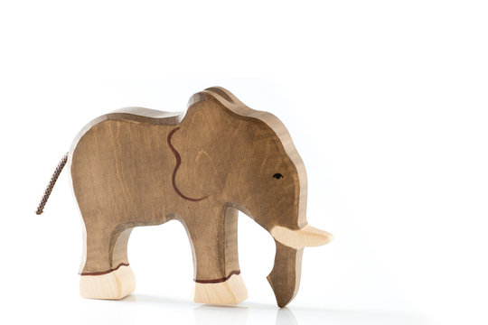 Wooden toy elephant figurine on white