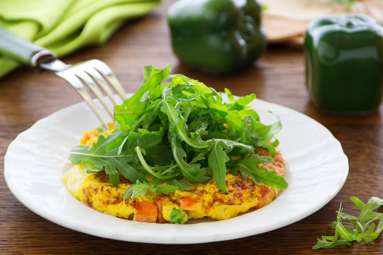 Frittata with vegetables and arugula.