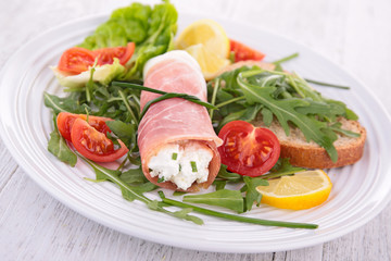 vegetable salad and ham rolled with cheese