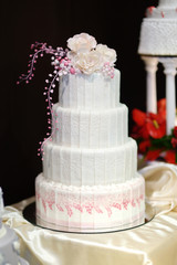 White wedding cake decorated with pink flowers