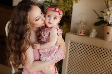 Portrait of a young mother and little daughter