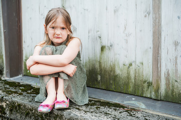 Angry little girl portrait outdoors © annanahabed