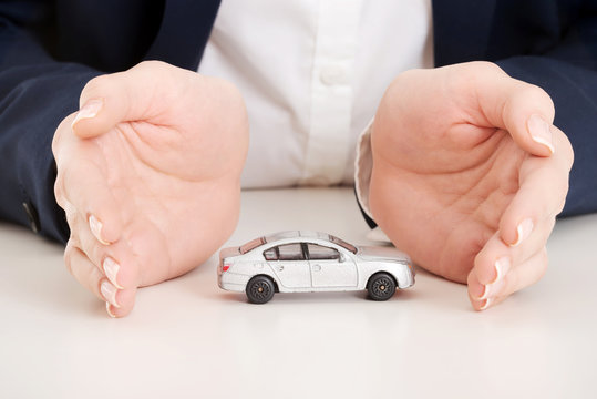 Close up on car toy model between hands.