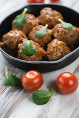 Close-up of meatballs with tomato sauce, vertical shot