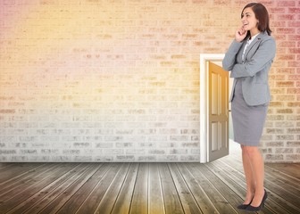 Composite image of smiling thoughtful businesswoman