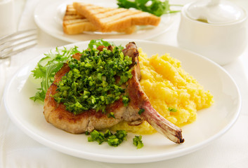 natural cutlet on the bone with polenta and gremolatoy.