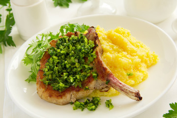 natural cutlet on the bone with polenta and gremolatoy.
