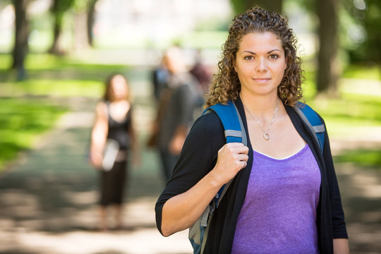 Confident Female Student Standing At Campus