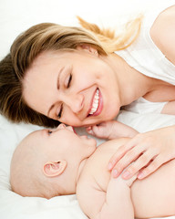Obraz na płótnie Canvas happy mother with baby over white