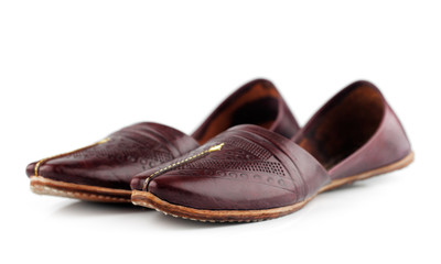 Traditional Arabic slippers shot against a white background