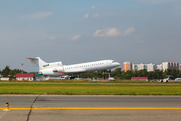 Fototapeta premium white plane takes off from the runway
