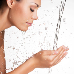 woman washing her clean face with water