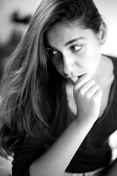 Black and white portrait of young woman thinking