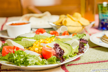 Traditional mexican food with nachos and salad