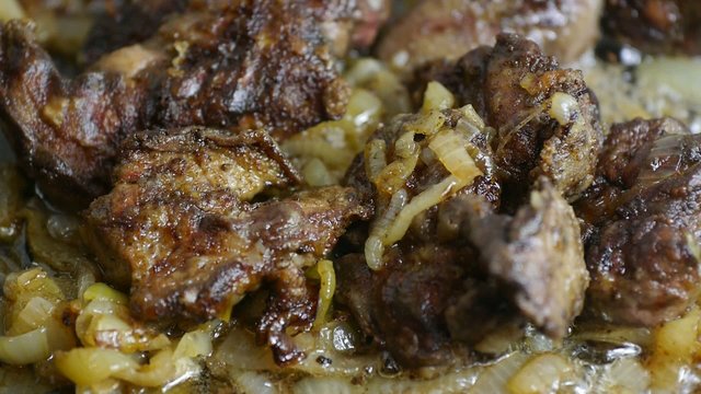 Fried liver with onion in a pan