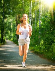 Running Woman. Outdoor Workout in a Park. Full Length Portrait
