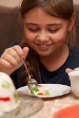 Obraz na płótnie Canvas Little girl eating a cake