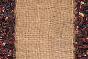 Dried hibiscus flowers petals lies on sackcloth