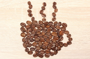 Cup shaped coffee beans on wooden background