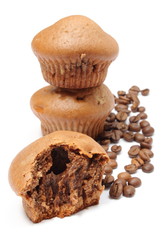 Fresh baked muffins and coffee grains on white background